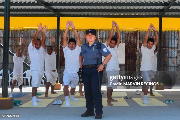 Nicol Gomez guardian at the La Esperanza prison poses for a portrait with a group of prisoners practicing yoga, in San Salvador, on March 4, 2018. In...