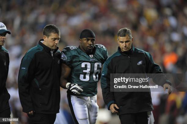 Running back Brian Westbrook of the Philadelphia Eagles is assisted off the field after getting injured during the game against the Washington...