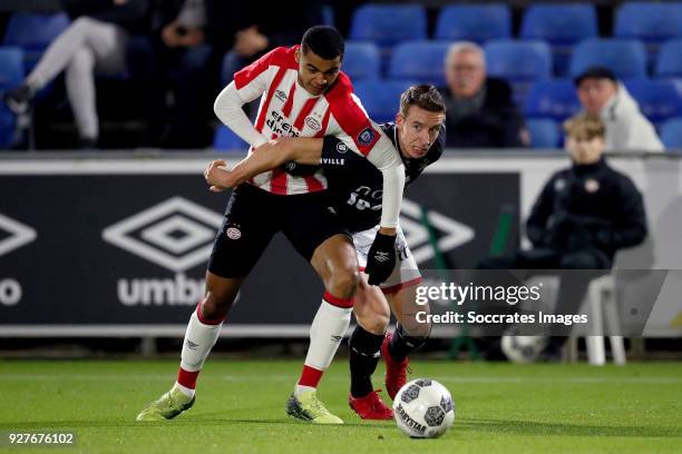 Cody Gakpo of PSV U23, Glenn Bijl of FC Emmen during the Dutch Jupiler League match between PSV U23 v FC Emmen at the De Herdgang on March 5, 2018 in...