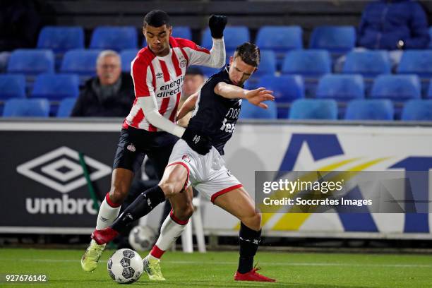 Cody Gakpo of PSV U23, Glenn Bijl of FC Emmen during the Dutch Jupiler League match between PSV U23 v FC Emmen at the De Herdgang on March 5, 2018 in...