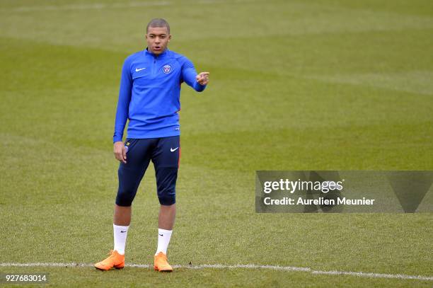 Kylian Mbappe warms up during a Paris Saint-Germain training session ahead of the Champion's League match against Real Madrid at Centre Ooredoo on...