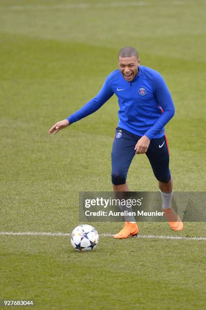 Kylian Mbappe warms up during a Paris Saint-Germain training session ahead of the Champion's League match against Real Madrid at Centre Ooredoo on...