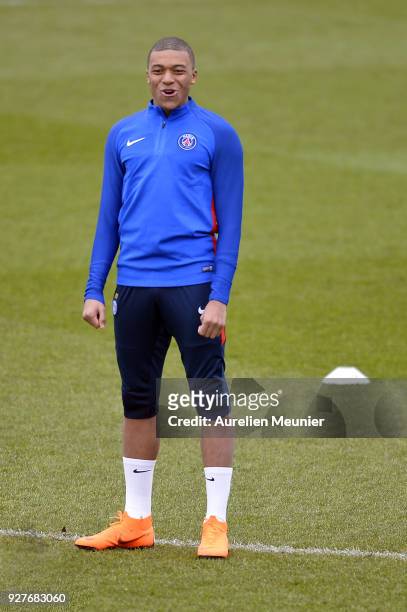 Kylian Mbappe warms up during a Paris Saint-Germain training session ahead of the Champion's League match against Real Madrid at Centre Ooredoo on...