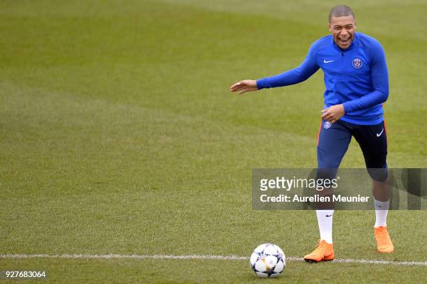 Kylian Mbappe warms up during a Paris Saint-Germain training session ahead of the Champion's League match against Real Madrid at Centre Ooredoo on...