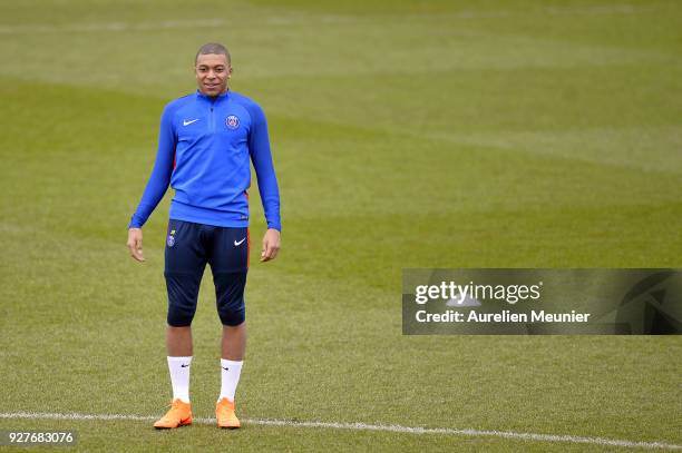 Kylian Mbappe warms up during a Paris Saint-Germain training session ahead of the Champion's League match against Real Madrid at Centre Ooredoo on...