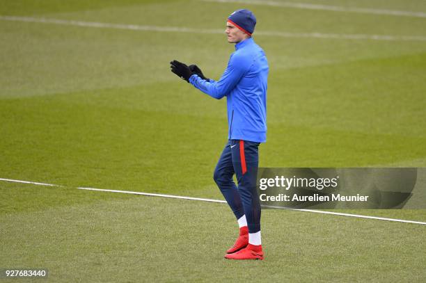 Edinson Cavani reacts as he arrives for a Paris Saint-Germain training session ahead of the Champion's League match against Real Madrid at Centre...