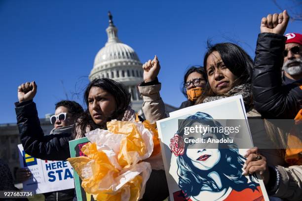 Demonstrators raise their fists in protest of President Trump's attempts to end the Deferred Action for Childhood Arrivals , an executive action made...