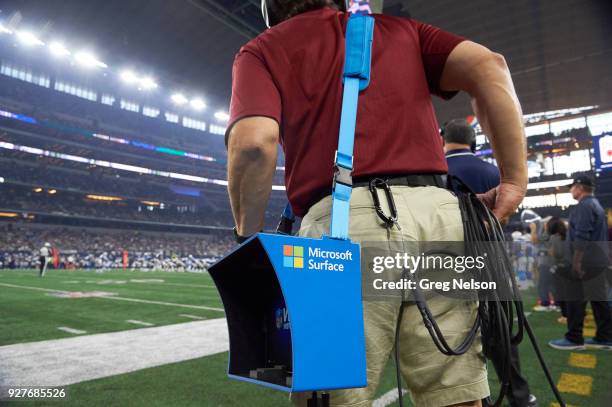 Closeup of assistant coach holding Microsoft Surface video equipment on sidelines during Dallas Cowboys vs Los Angeles Chargers game at AT&T Stadium....