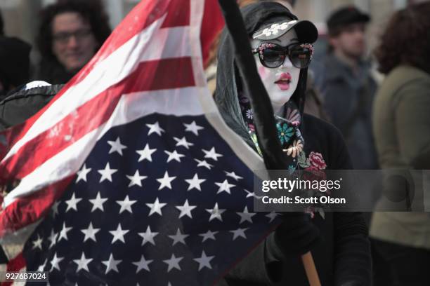 Demonstrators at Michigan State University protest a speech by white nationalist Richard Spencer, who popularized the term 'alt-right', on March 5,...