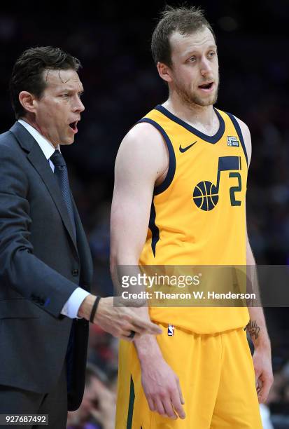 Head coach Quin Snyder of the Utah Jazz talks with his player Joe Ingles while there's a break in the action against the Sacramento Kings during an...