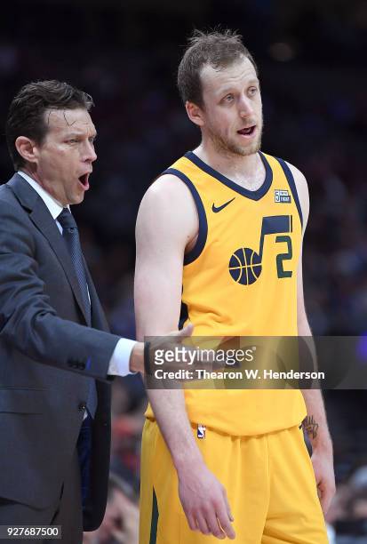 Head coach Quin Snyder of the Utah Jazz talks with his player Joe Ingles while there's a break in the action against the Sacramento Kings during an...