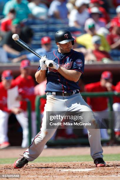 Chris Heisey of the Minnesota Twins gets hit by a pitch during the fourth inning of the spring training game against the Philadelphia Phillies at...