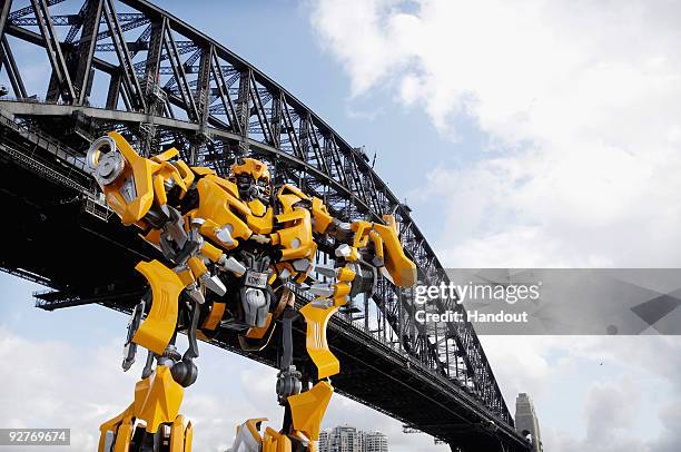 Transformers robot Bumblebee, which stands at 5 metres tall and weighs 3 tonnes, tours Sydney Harbour by barge to launch the DVD of "Transformers:...