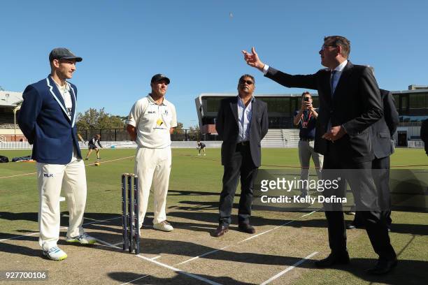 Peter Neville Captain of the New South Wales Blues and Aaron Finch Captain of the Victorian Bushrangers watch as Victorian Premier Daniel Andrews...