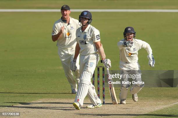 Sean Abbott of the NSW Blues reacts after he is out and the VIC Bushrangers celebrate during day one of the Sheffield Shield match between Victoria...
