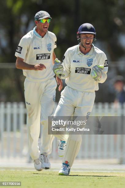 Peter Nevill celebrates the NSW Blues taking a wicket from Cameron White of the VIC Bushrangers during day one of the Sheffield Shield match between...