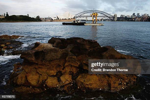 Transformers robot Bumblebee, which stands at 5 metres tall and weighs 3 tonnes, tours Sydney harbour by barge to launch the DVD of "Transformers:...