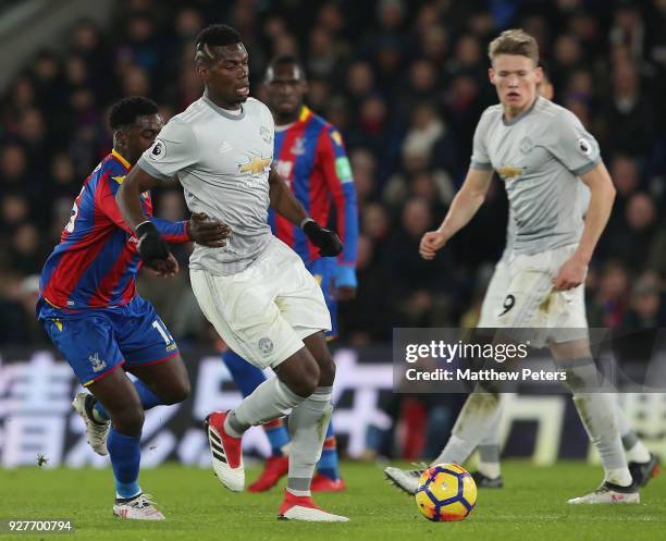 Paul Pogba of Manchester United in action with Jeffrey Schlupp of Crystal Palace during the Premier League match between Crystal Palace and...