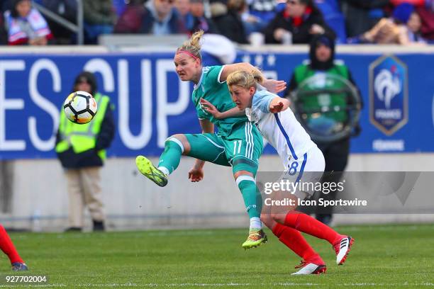 Germany forward Alexandra Popp battles England forward Ellen White during the first half of the SheBelieves Cup Womens Soccer game between Germany...