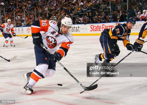 Matt Moulson of the New York Islanders controls the puck against Jason Pominville of the Buffalo Sabres on November 4, 2009 at HSBC Arena in Buffalo,...