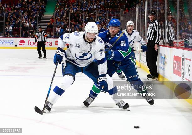 Brendan Gaunce of the Vancouver Canucks checks Victor Hedman of the Tampa Bay Lightning during their NHL game at Rogers Arena February 3, 2018 in...