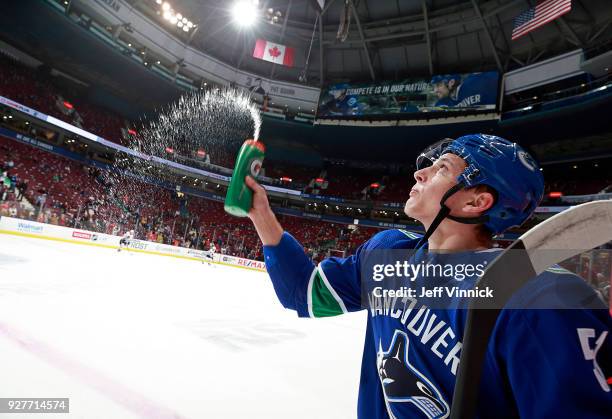 Troy Stecher of the Vancouver Canucks sprays water during their NHL game against the Chicago Blackhawks at Rogers Arena December 28, 2017 in...