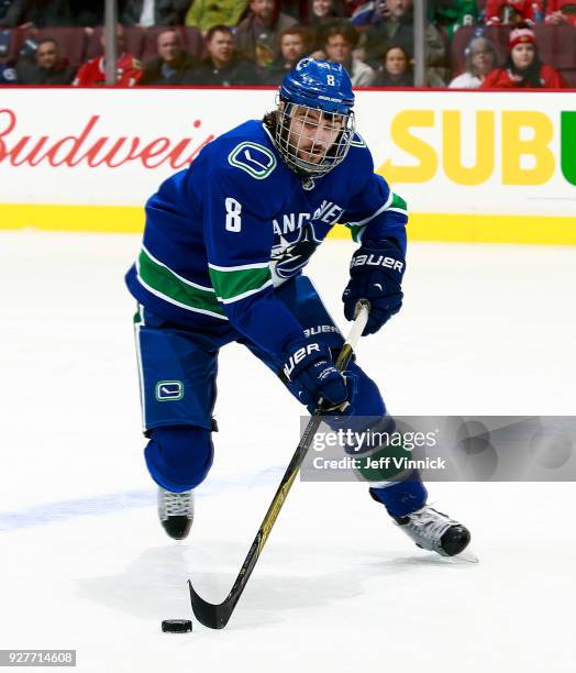 Christopher Tanev of the Vancouver Canucks skates up ice with the puck during their NHL game against the Chicago Blackhawks at Rogers Arena December...