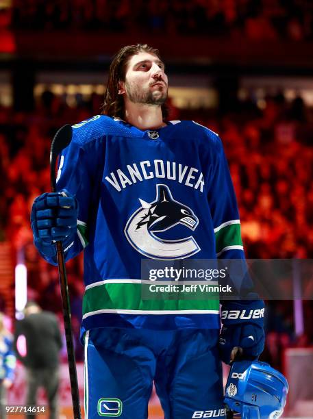 Christopher Tanev of the Vancouver Canucks listens to the national anthem during their NHL game against the Chicago Blackhawks at Rogers Arena...