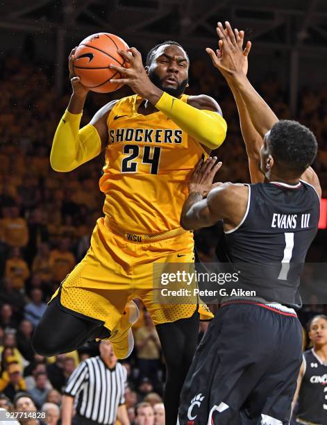 Shaquille Morris of the Wichita State Shockers grabs a rebound against Jacob Evans of the Cincinnati Bearcats during the first half on March 4, 2018...