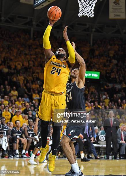 Shaquille Morris of the Wichita State Shockers scores a basket against Kyle Washington of the Cincinnati Bearcats during the first half on March 4,...