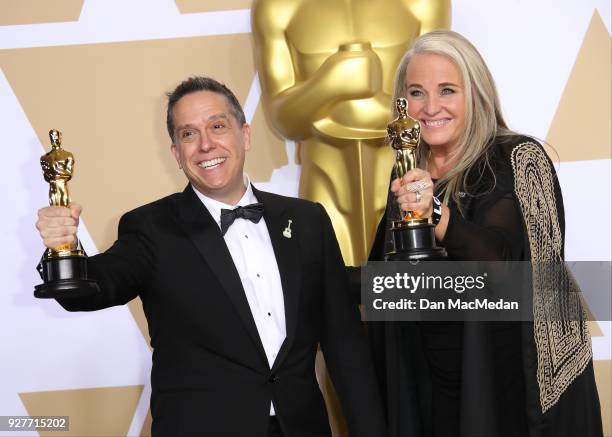 Filmmakers Lee Unkrich and Darla K. Anderson, winners of the Best Animated Feature Film for 'Coco,' pose in the press room at the 90th Annual Academy...