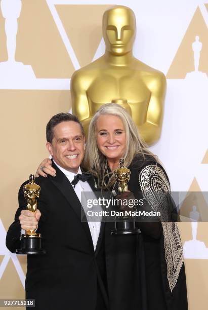 Filmmakers Lee Unkrich and Darla K. Anderson, winners of the Best Animated Feature Film for 'Coco,' pose in the press room at the 90th Annual Academy...