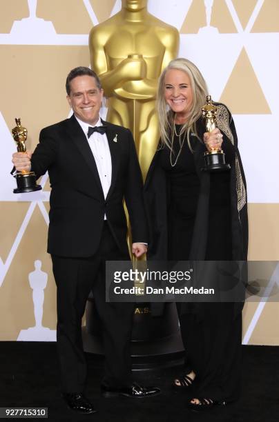 Filmmakers Lee Unkrich and Darla K. Anderson, winners of the Best Animated Feature Film for 'Coco,' pose in the press room at the 90th Annual Academy...