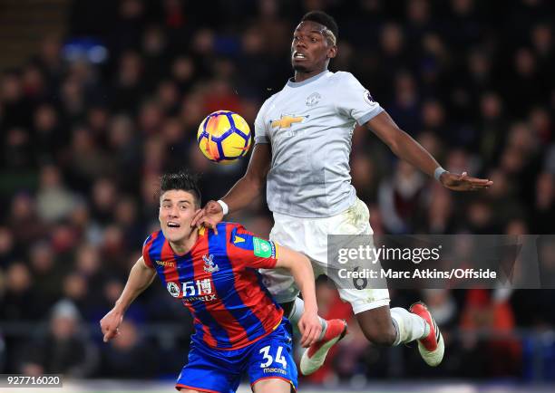 Paul Pogba of Man Utd jumps up behind Martin Kelly of Crystal Palace to chest the ball during the Premier League match between Crystal Palace and...