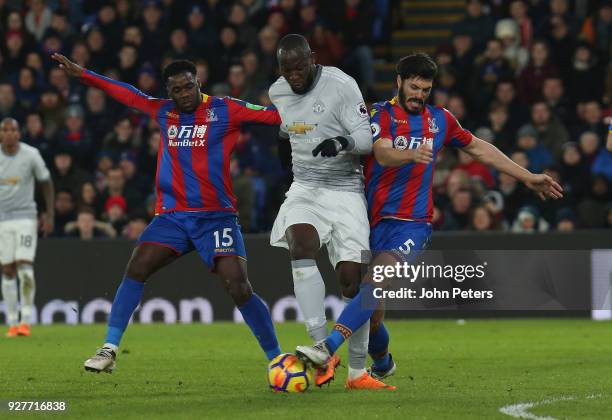 Romelu Lukaku of Manchester United in action with Jeffrey Schlupp and James Tomkins of Crystal Palace during the Premier League match between Crystal...