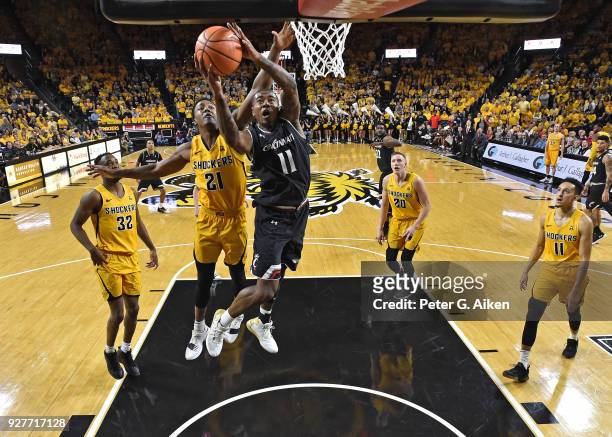 Gary Clark of the Cincinnati Bearcats drives to the basket against Darral Willis Jr. #21 of the Wichita State Shockers during the first half on March...
