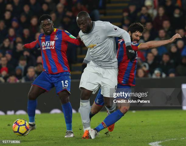 Romelu Lukaku of Manchester United in action with Jeffrey Schlupp and James Tomkins of Crystal Palace during the Premier League match between Crystal...