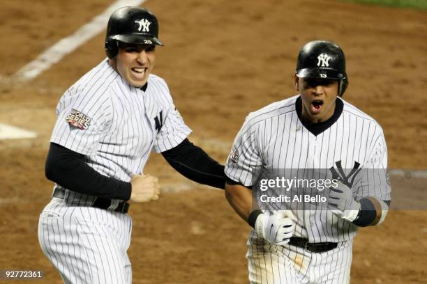 Mark Teixeira and Alex Rodriguez of the New York Yankees celebrate after they scored on a 2-run double by Hideki Matsui in the bottom of the fifth...