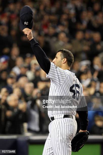 Andy Pettitte of the New York Yankees tips his hat to the crowd as he was taken out of the game in the top of the sixth inning against the...