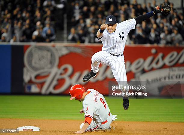 Derek Jeter of the New York Yankees turns a double play in the top of the first inning of Game Six of the 2009 MLB World Series against the...