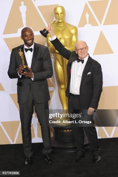 Filmmaker/former NBA player Kobe Bryant and filmmaker Glen Keane, winners of the Animated Short award for ?'Dear Basketball'? pose inside the Press...