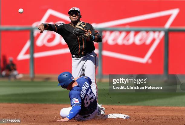 Infielder Miguel Gomez of the San Francisco Giants throws over the sliding Scott Heineman of the Texas Rangers to complete a double play during the...