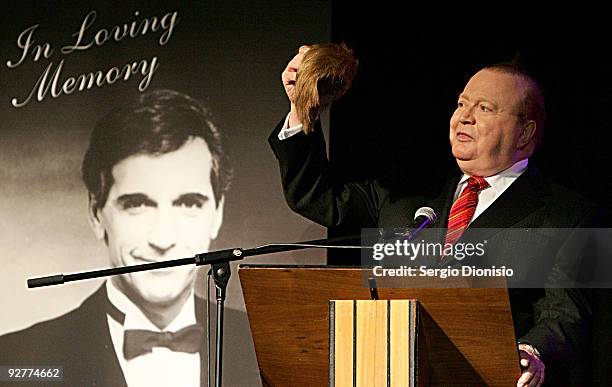 Entertainer Bert Newton removes his toupee on stage during the Don Lane Public Memorial Celebration on November 5, 2009 in Sydney, Australia.