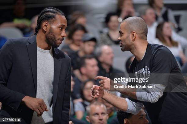 Kawhi Leonard of the San Antonio Spurs talks with Tony Parker of the San Antonio Spurs during the game against the New Orleans Pelicans on February...