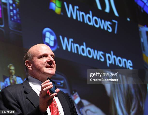 Steve Ballmer, chief executive officer of Microsoft Corp., shows a Windows mobile phone during a news conference in Tokyo, Japan, on Thursday, Nov....