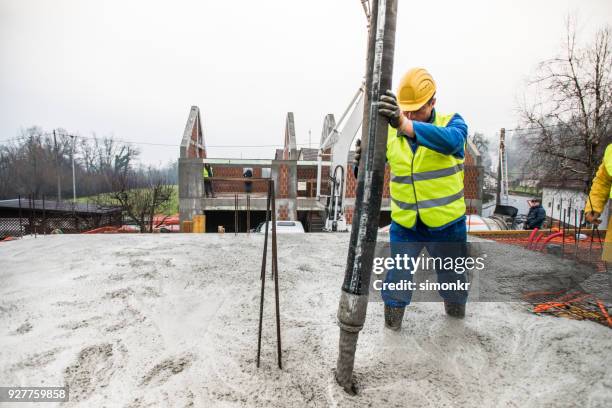 construction workers pouring cement on roof - builders boots stock pictures, royalty-free photos & images