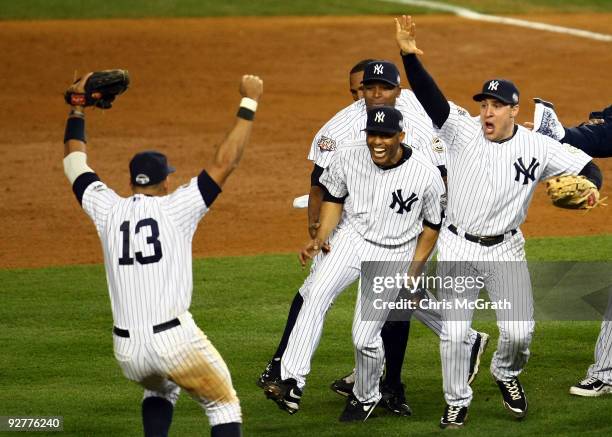 Mariano Rivera and Mark Teixeira of the New York Yankees runs towards Alex Rodriguez and his teammates as they celebrate after their 7-3 win against...
