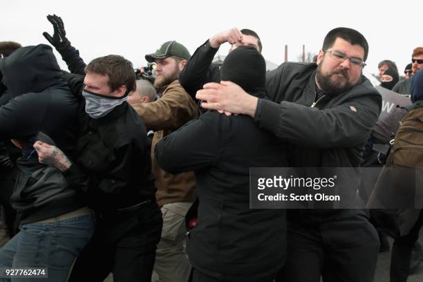 White nationalist Matthew Heimbach fights with demonstrators at Michigan State University as he and other alt-right advocates try to attend a speech...