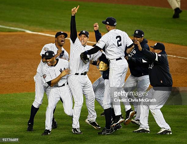 Mariano Rivera , Damaso Marte, Mark Teixeira and Derek Jeter of the New York Yankees celebrate with teammates after their 7-3 win against the...