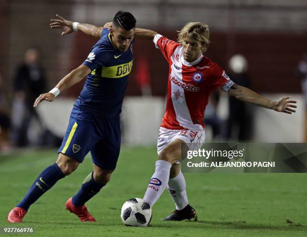 Boca Juniors' forward Cristian Pavon vies for the ball with Argentinos Juniors' midfielder Gaston Machin during their Argentina First Division...